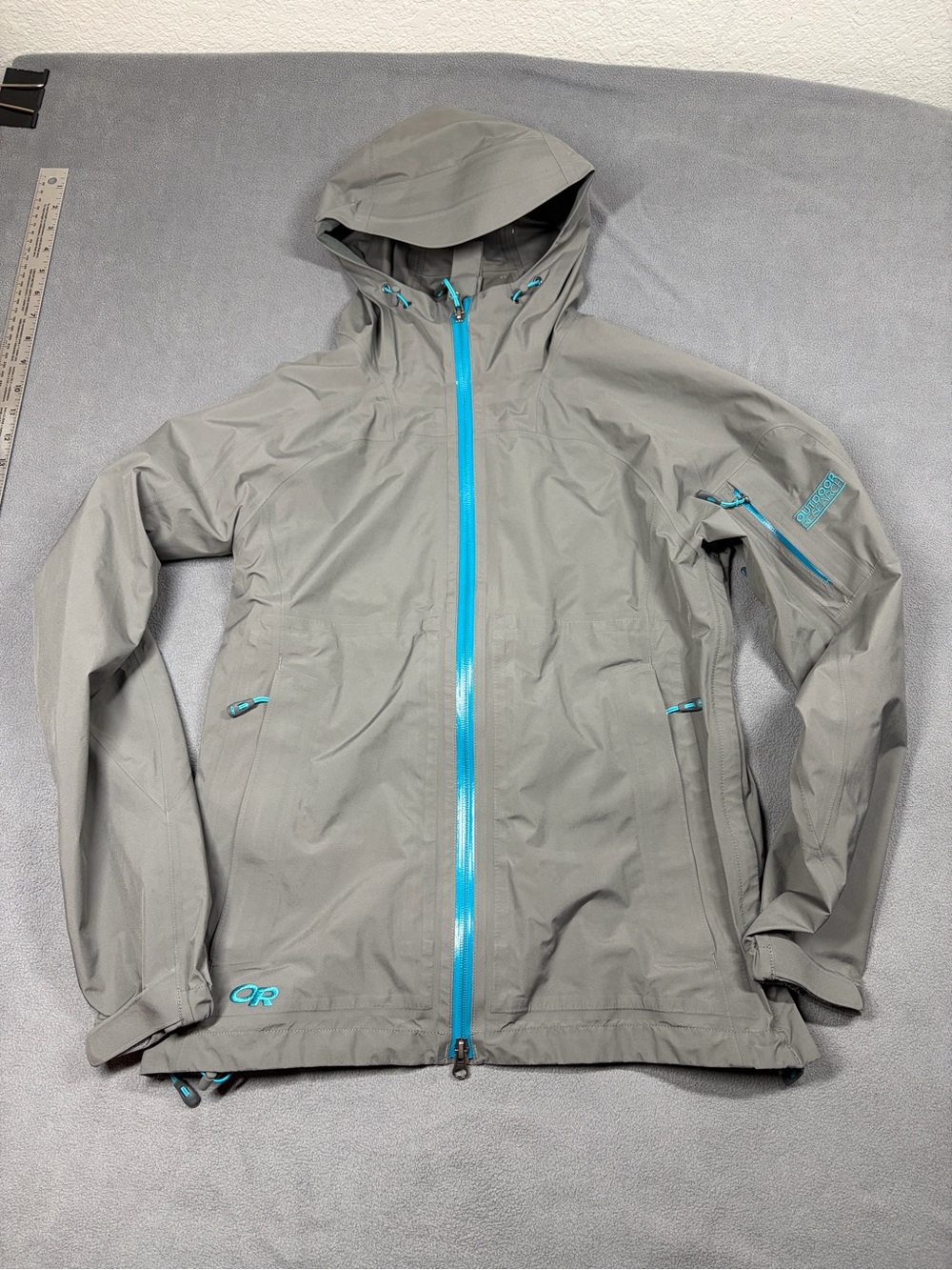 Outdoor Research Light Gray Waterproof Hooded Jacket with Teal Zipper